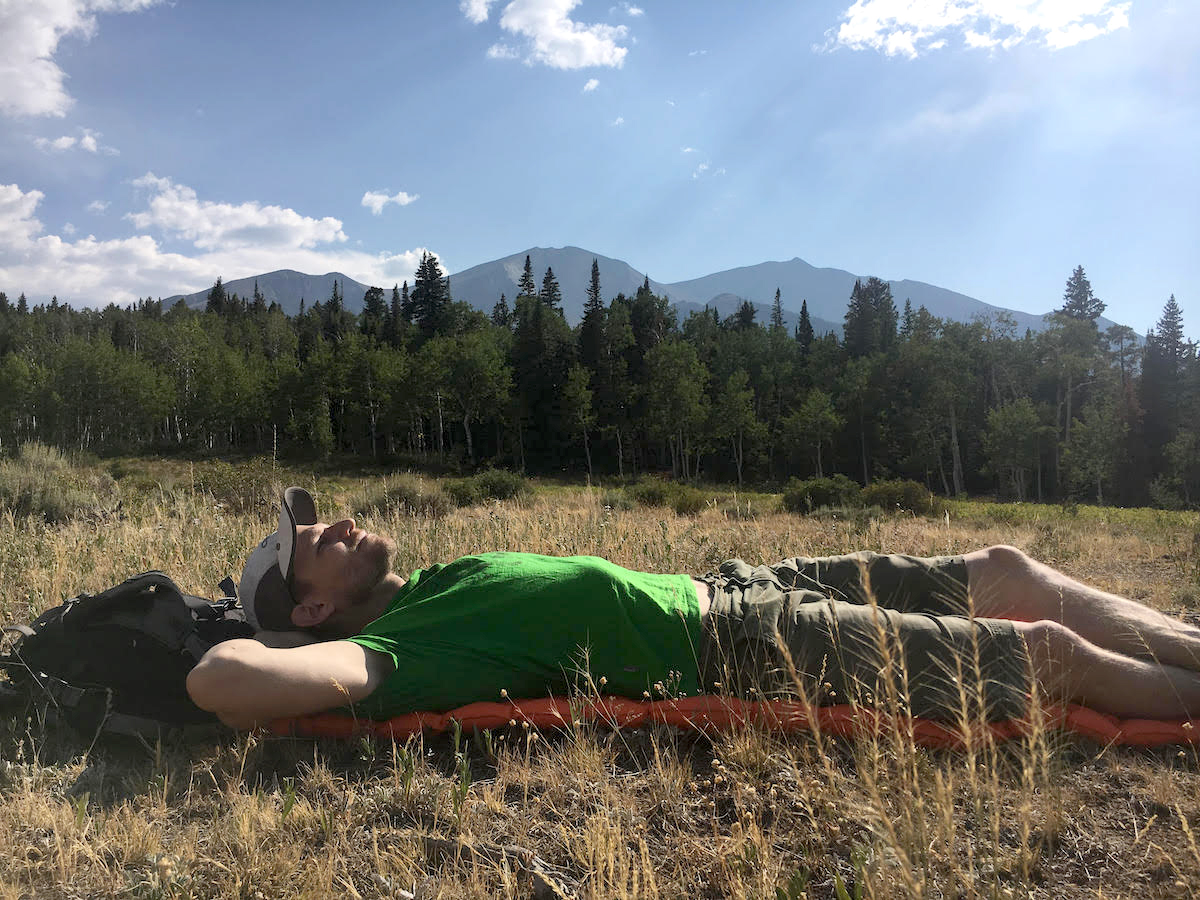 The author lounges on the Sea to Summit Ultralight Air Mat in Colorado's Elk Range with Mt. Sopris (12,965') in the background. [Photo] Amanda Franz
