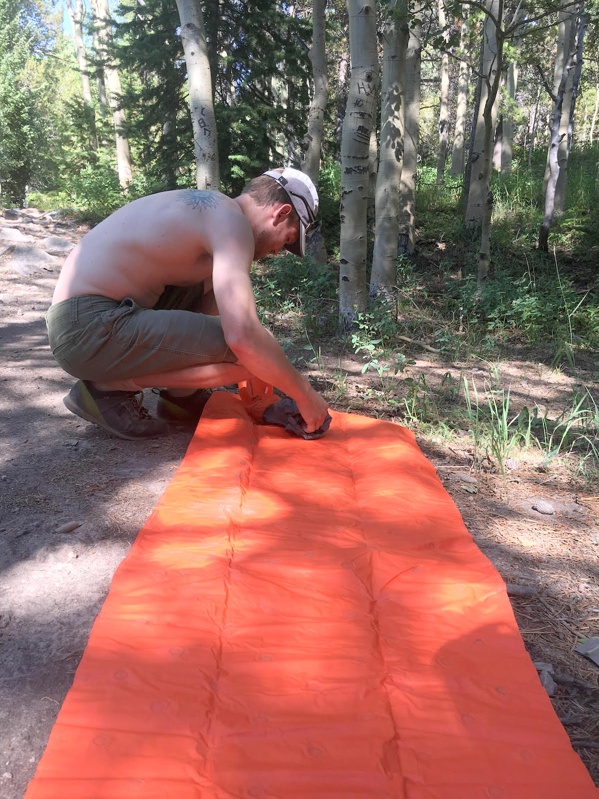 The author setting up the pump sack for the Sea to Summit Ultralight Air Mat. After a small amount of practice, three pumps are plenty to inflate the mattress. [Photo] Amanda Franz