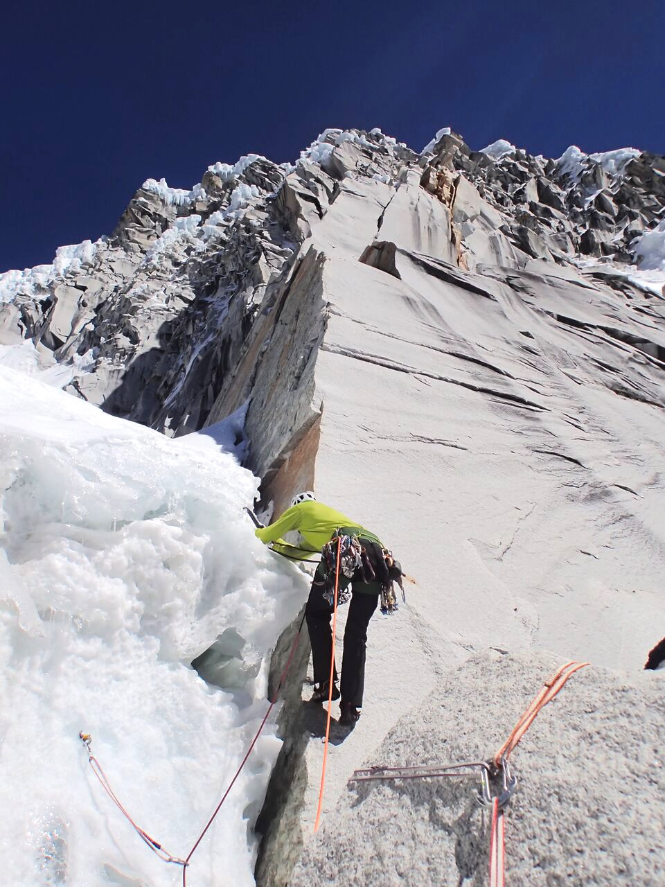 Steve Skelton leading across perfect alpine terrain on the East Face Rock Rib. Dropping a pack for this crux pitch, the team climbed 12 pitches of alpine rock to gain the north ridge approximately 300 feet from the summit. [Photo] Ben Dare