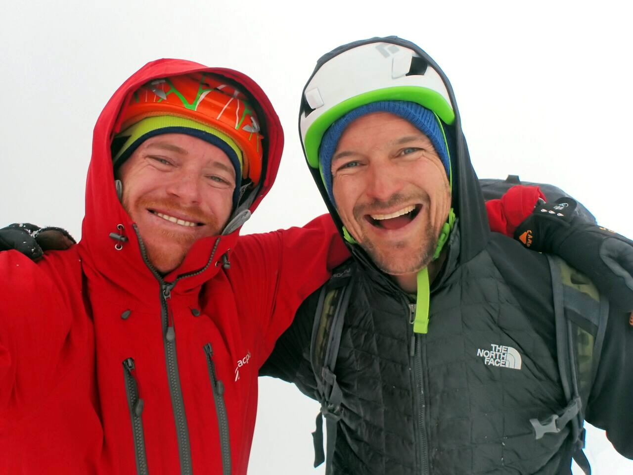 Ben Dare (left) and Steve Skelton (right), happy and a little teary eyed on a view-less summit after completing their new route on Taulliraju. [Photo] Ben Dare