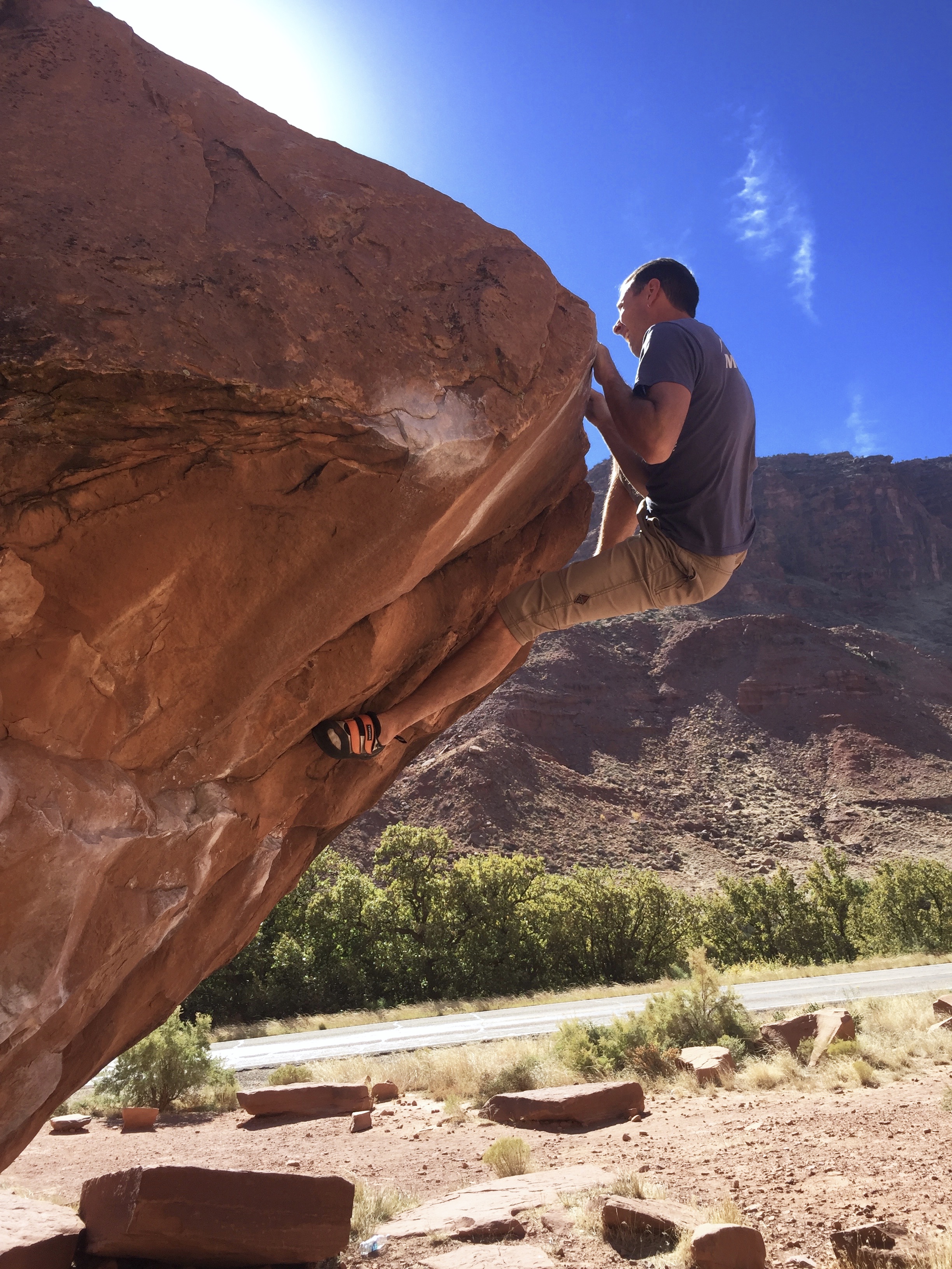 Mike Lewis rocks onto his right foot to finish Circus Trick (V5) at the Big Bend Boulders near Moab, Utah. [Photo] Drew Maloney