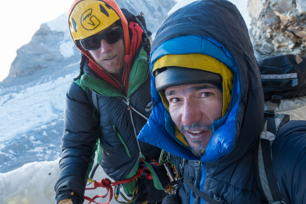 Rousseau, left, and Villanueva pause for a selfie above the last 800 meters of rappels. This was their eighth consecutive day on the move and they had run out of food the previous day after summiting. [Photo] Tino Villanueva