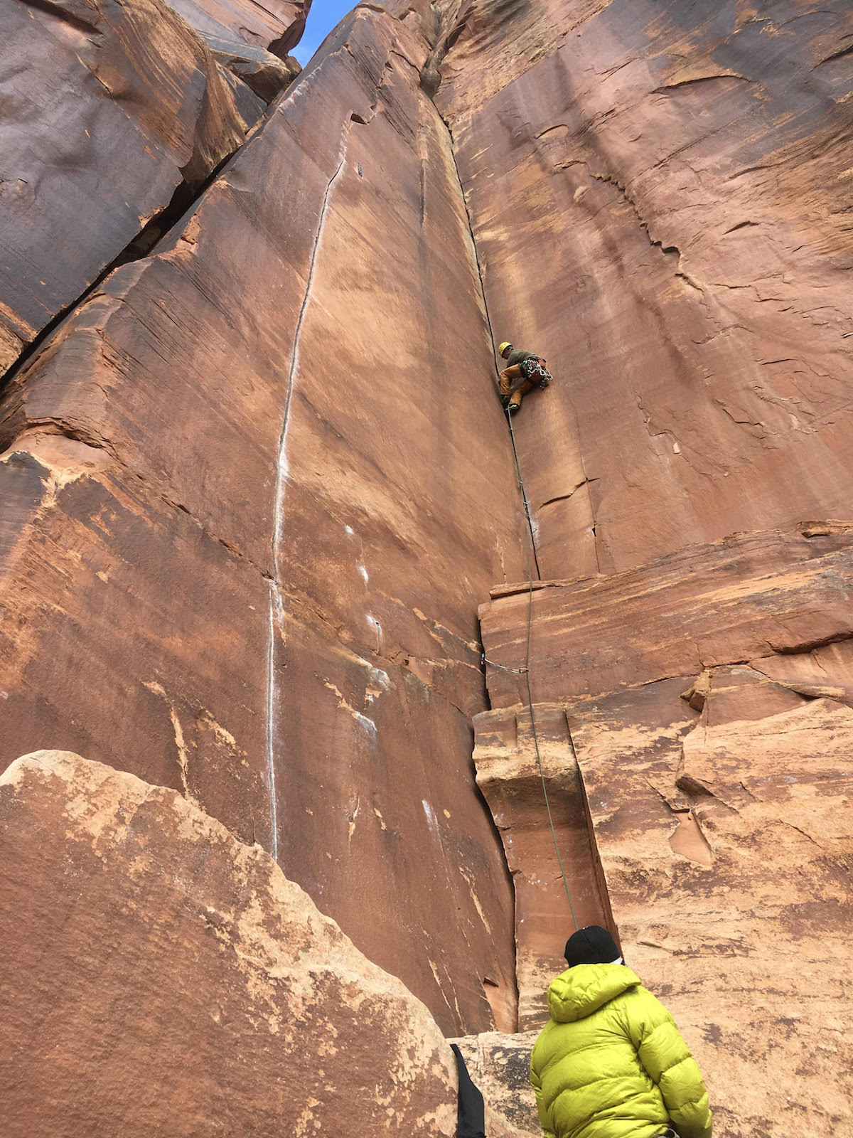 A climber leads Three Strikes You're Out (5.11, 90') on the Battle of the Bulge Buttress in Indian Creek, Utah. The area is part of Bears Ears National Monument where US Interior Secretary Ryan Zinke is conducting a visit as part of his review of all national monuments designated in the last 21 years--as ordered by President Donald Trump in April. Conservation groups fear the unprecedented review could result in these monuments being rescinded or reduced. [Photo] Derek Franz