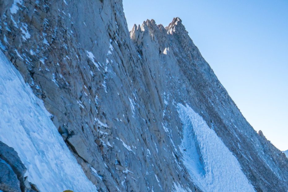 Whitney Clark traverses to the belay after climbing the hanging glacial ice midway up a new route (Land of Milk and Honey, IV 5.8+ M3 R 65 degrees, 1,000') on the northwest face of Mt Russell (14,094') in the Sierra Nevada Range, California. [Photo] Tad McCrea