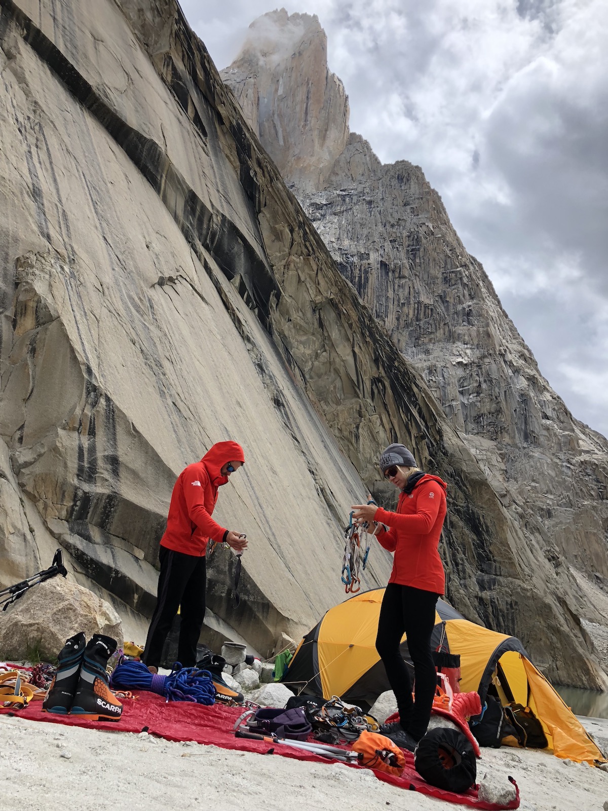 David Allfrey and Anna Pfaff sort gear to carry to their high camp (5330m) below the Trango tower and Great Trango tower. [Photo] Andres Marin