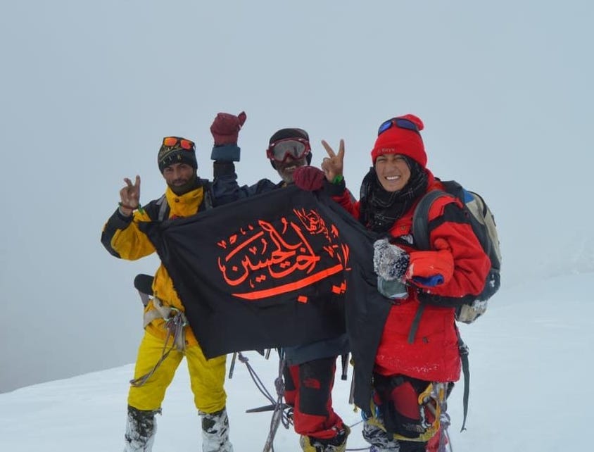 Amina Shigri on the summit of Khusar Gang in August 2021 with her father and brother