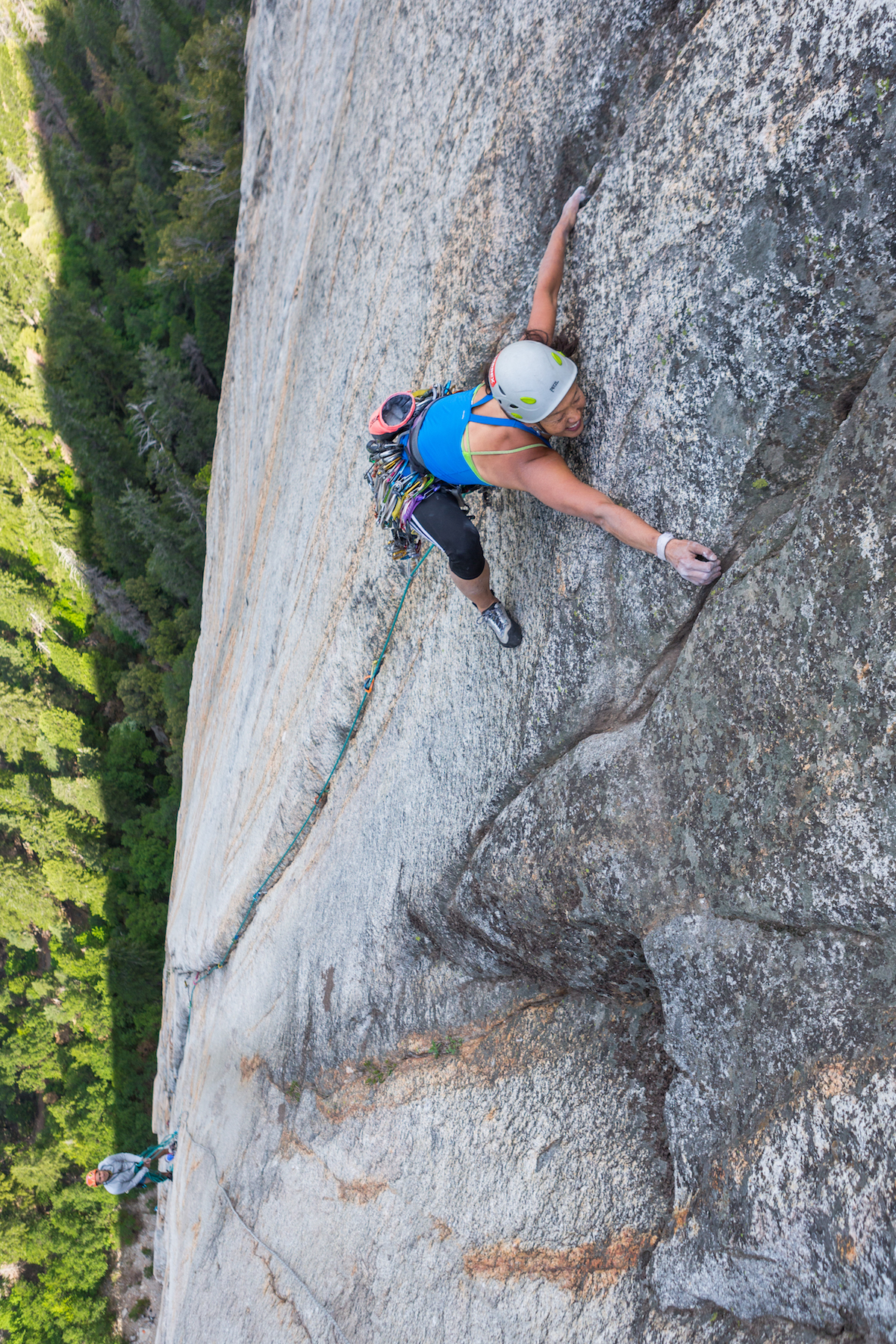 Rita Shin fires Cosmic Girl (5.12+, 1,200') on Yosemite's Middle Cathedral. The route starts on the Chouinard-Pratt route--which is the same start as the modern version of the extremely popular Central Pillar of Frenzy (5.9)--but Cosmic Girl continues straight up where the Central Pillar traverses left into another crack system. [Photo] John Evans