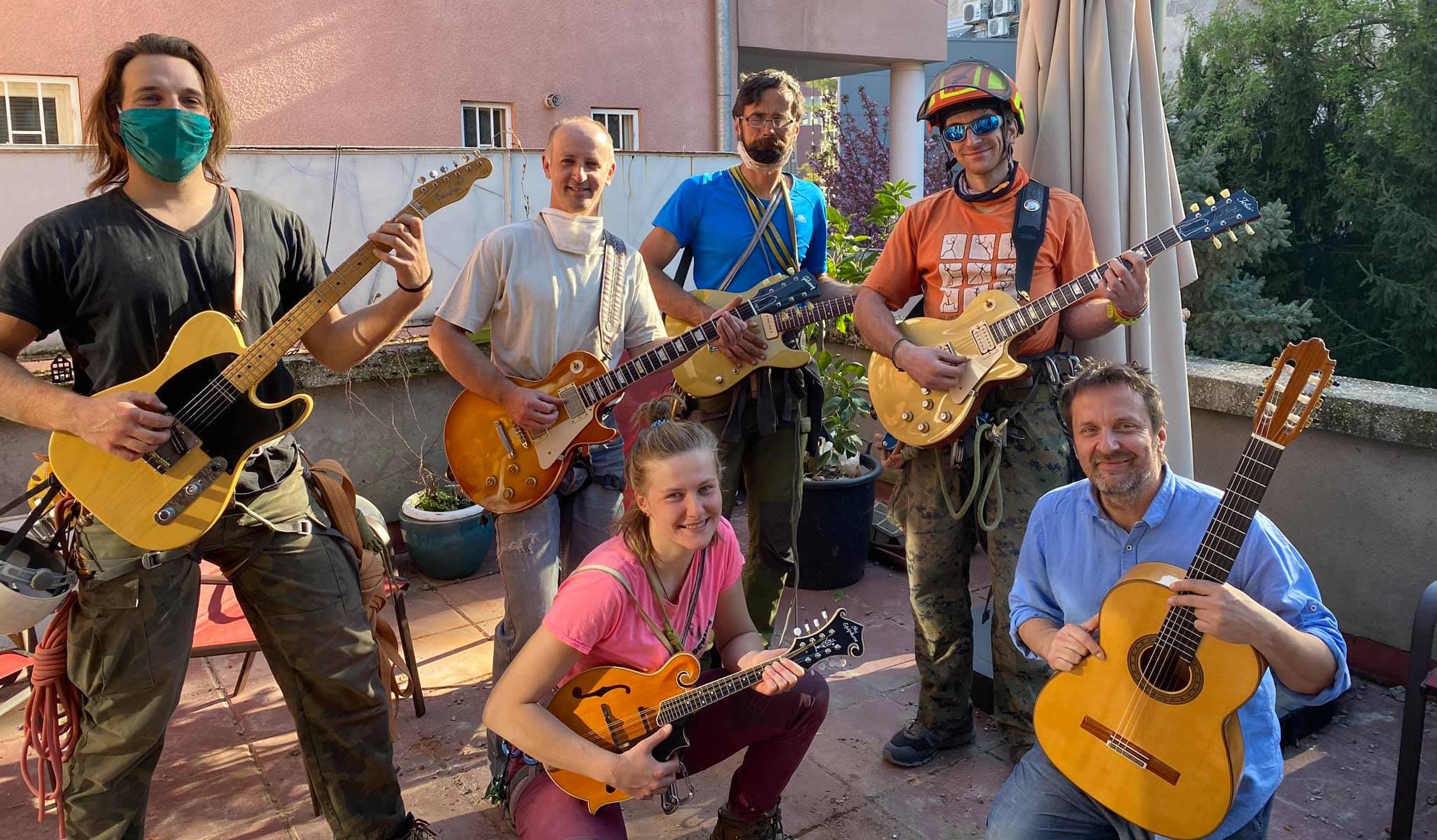 Well-known Croatian jazz musician Ante Gelo (lower right) poses with volunteers who cleared his roof from the loose material. Gelo played for them while they were working on the roof and showed them a collection of his fine guitars. [Photo] Courtesy of Ante Gelo